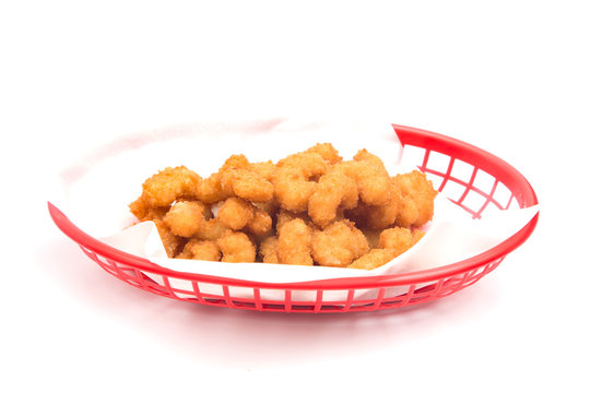 Battered and Fried Popcorn Shrimp in a Basket on a White Background