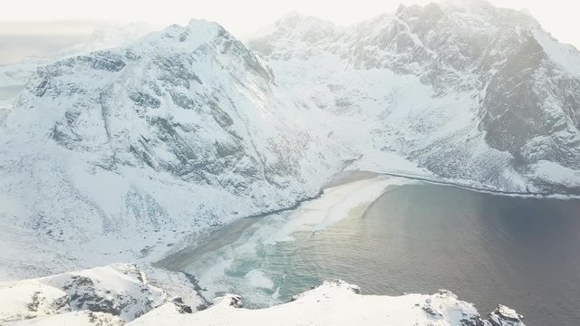 View of mountain landscape in Northern Norway, Lofoten Islands, Nordland, on the way to Ryten mountain and Kvalvika beach, with a groups of hikers, and mountains around, sunny winter day
