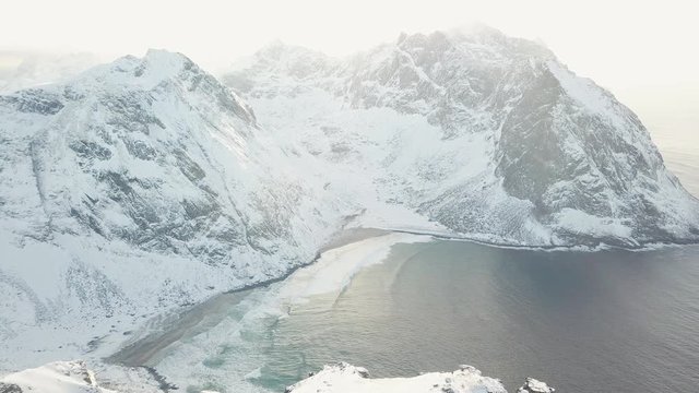 View of mountain landscape in Northern Norway, Lofoten Islands, Nordland, on the way to Ryten mountain and Kvalvika beach, with a groups of hikers, and mountains around, sunny winter day
