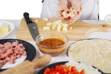 Unknown female chef holding slices mozzarella