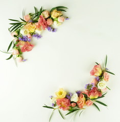 Flowers background. Wreath frame made of  pink and purple  flowers and eucalyptus branches on a white background. Flat lay. top view. copy space