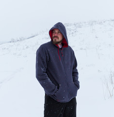 Man wearing blank grey hoodie, in the urban background near the river