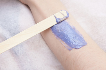 purple wax arm depilation