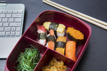 Laptop and lunch box on the table
