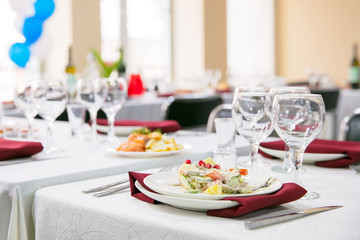 Served banquet table with salad on plate