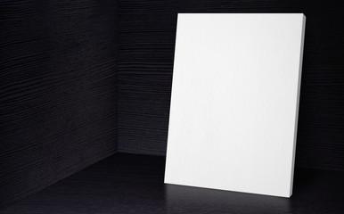 Blank poster at corner studio room with black wooden wall and floor background,Mock up studio room for display or montage of product for advertising on media,Business presentation