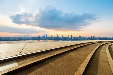 Fototapeta premium empty concrete floor and modern buildings in midtown of singapore in blue cloud sky