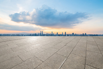 empty concrete floor and modern buildings in midtown of singapore in blue cloud sky