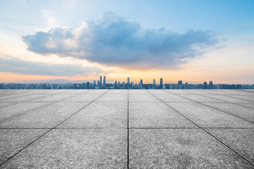 empty concrete floor and modern buildings in midtown of singapore in blue cloud sky