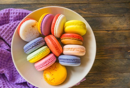 French pastries multicolored macaroon on a wooden background