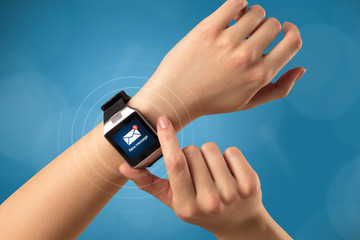 Hand with smartwatch and blue background