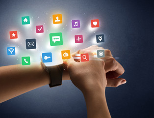 Female hand wearing smartwatch with app icons