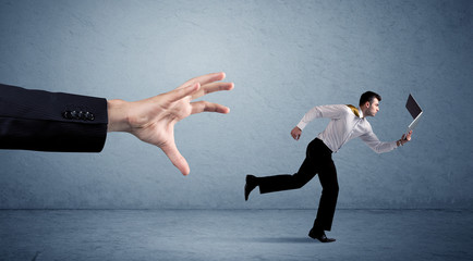 Businessman running from hand