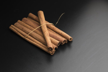 cinnamon sticks on black background