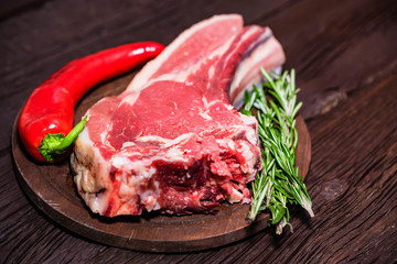 Raw beef steak with pepper and rosemary