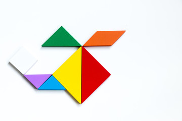 Colorful wood tangram puzzle in helicopter shape on white background