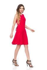 Walking Woman In Red Dress And High Heels Is Smiling