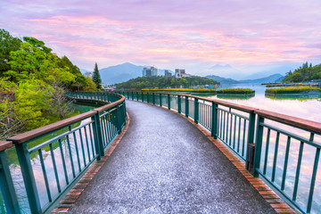 Fototapeta premium Landscape view of Sun Moon Lake with colorful sunrise sky dawn morning, the most famous tourist attraction in Taiwan.