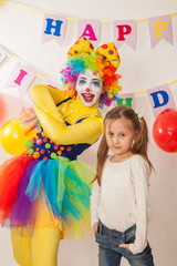 clown girl on the birthday of a child. A party for a child. Fun and smile