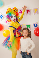 clown girl on the birthday of a child. A party for a child. Fun and smile