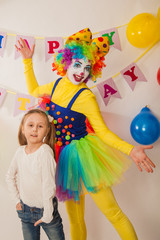 clown girl on the birthday of a child. A party for a child. Fun and smile