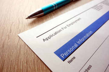 Application for employment form and pen on desk