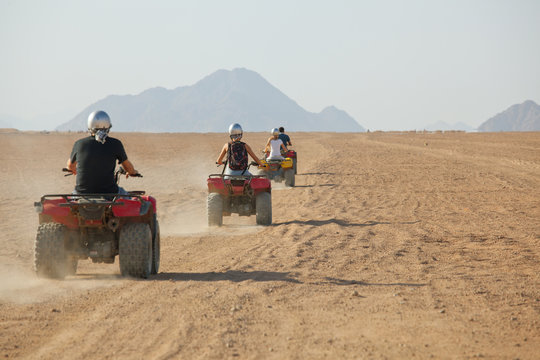 high speed race of several people riding quad bikes in desert of Egypt