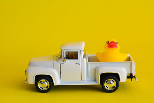 Duck on vintage pickup truck abstract minimal yellow background, Car concept