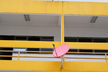 Red Satellite Dish on a Second Floor