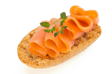 Bread with fresh salmon fillet isolated on white background, top view.
