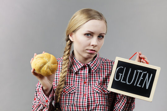 Woman holding board with gluten and bread