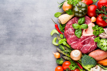 Raw fresh meat Ribeye Steak with vegetables and spice.