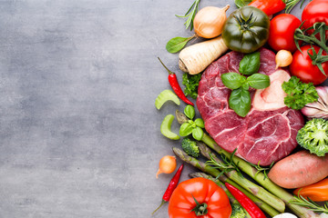 Raw fresh meat Ribeye Steak with vegetables and spice.