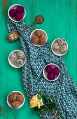 Colourful Bliss Balls on Textured Green Backdrop