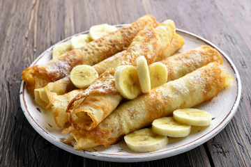 Thin pancakes, crepes roll with banana slices