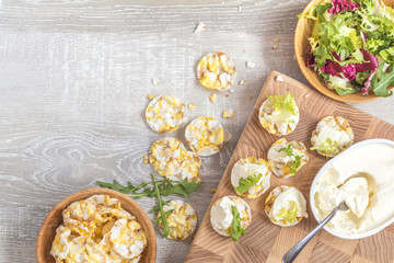 Delicious nutritious cereal breads with cream cheese on kitchen table