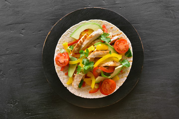 Taco with chicken meat and vegetables