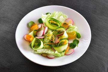 Vegetable salad on dark stone background