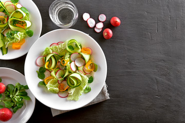 Healthy vegetable salad on dark background