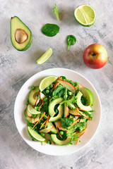 Salad with avocado, green pea, greens, apple