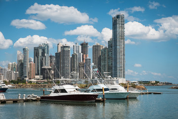 Fototapeta na wymiar Panama city skyline and yacht boats docked on harbor