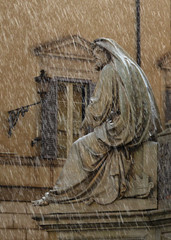 Old sculpture under the rain on the street of Rome Italy 15.06.2014
