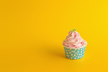 Tasty Birthday cupcake on yellow color background