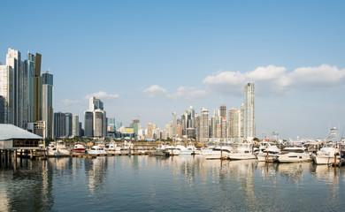 Fototapeta na wymiar Vacations and Tourism Concept - modern yachts at harbor in Panama with city skyline