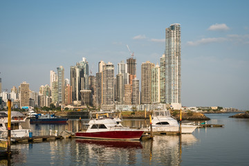 Fototapeta na wymiar yacht boats on harbor in Panama City with business district skyline