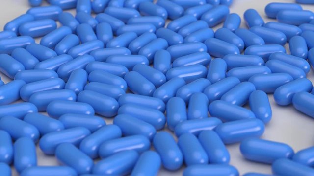 Blaue Tabletten - Pillen fallen auf den Boden