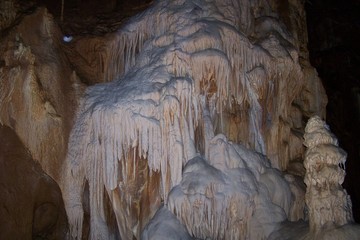Stalactites and stalagmites inside a cave © E-lona