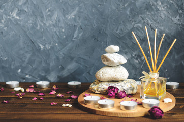 Fototapeta na wymiar Spa composition-stones, candles, aromatherapy, dry flowers.