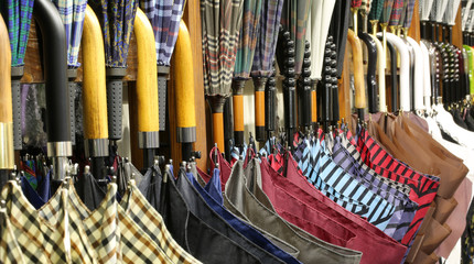 many umbrellas with wooden handles for sale in the shop