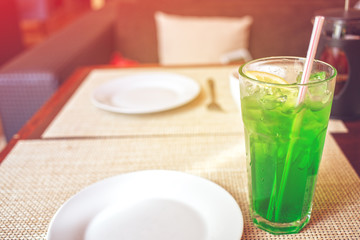 sweet herb drink emerald green color. Is made out of the water, lemon, sugar and the tarragon